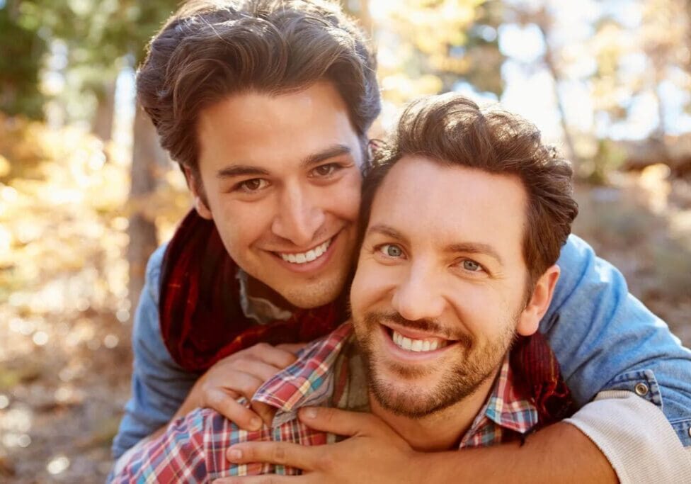 Two men are smiling for the camera.